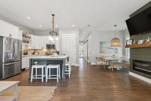 a kitchen with white cabinets and a blue island at Aquamarine! Sleeps 12! Close to Community Pool! Private Beach Access! in Blue Mountain Beach