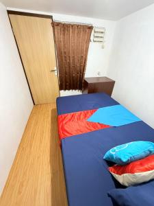 a small room with a bed and a door at Ambon Residence Syariah in Ambon +26 photos