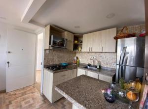 a kitchen with a refrigerator and a counter top at Apartamento amoblado valle de Lili, Dolce Vita in Cali