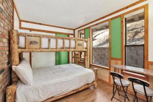 a bedroom with bunk beds and a table and chairs at Moonlight ridge - 1929 in Big Bear Lake