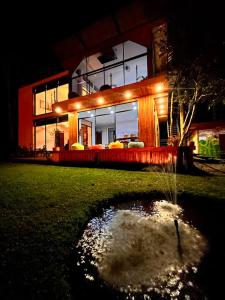 a house with a pond in the yard at night at Casa Fénix Zen Oasis Del Bosque in Calima +77 photos