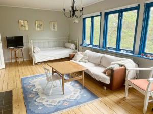 a living room with a couch and a table at 5 person holiday home in VÄRMDÖ in Värmdö