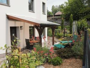 a patio with awning in front of a house at 1-bedroom holiday apartment in Naundorf