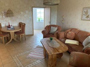 a living room with a couch and a table at Holiday apartment with 2 bedrooms in Hasselberg