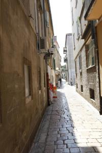 un callejón en un viejo pueblo con gente caminando por él en Apartment Vallamar free parking, en Zadar