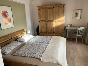 a bedroom with a bed and a table and a desk at Holiday home in Karby with swimming pool in Karby