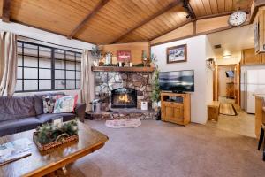 a living room with a couch and a fireplace at Brown bears cabin #1091 in Big Bear Lake