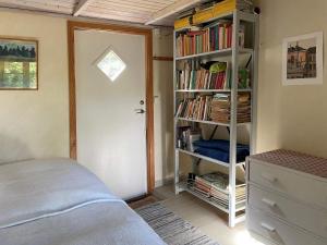 a bedroom with a book shelf filled with books at 4 star holiday home in DEGEBERGA in Degeberga