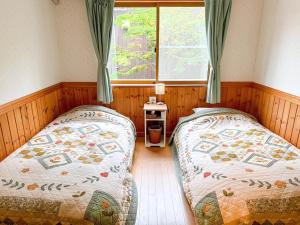 Postel nebo postele na pokoji v ubytování Guest House Chaconne Karuizawa
