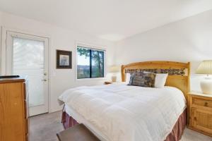 a bedroom with a large bed and a window at Bear golf inn #1218 in Big Bear Lake