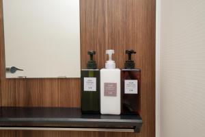 two bottles ofodorizers sitting on a shelf in a room at 銀座線徒歩9分 松が谷アパート in Tokyo +164 photos
