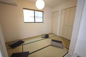 Postel nebo postele na pokoji v ubytování 福の荘 空港2号棟
