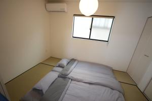 Postel nebo postele na pokoji v ubytování 福の荘 空港2号棟