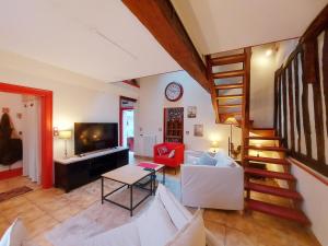 un soggiorno con una scala, un divano e un tavolo di Maison avec jardin à Châteaudun, près de Paris - FR-1-581-149 a Châteaudun