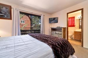a bedroom with a bed and a large window at Brown bears cabin #1091 in Big Bear Lake