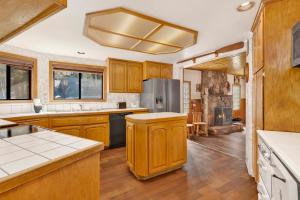 a large kitchen with wooden cabinets and a stove at Lake shore #012 in Big Bear Lake