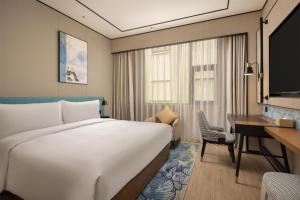 Postel nebo postele na pokoji v ubytování Hilton Garden Inn Chengdu Jinniu Yipintianxia