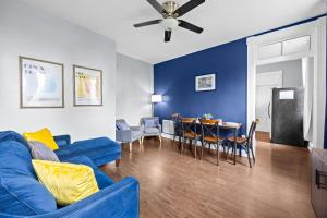a living room with a blue couch and a table at Newly-renovated Stylish Home in Louisville KY in Louisville