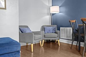 a living room with two chairs and a couch at Newly-renovated Stylish Home in Louisville KY in Louisville +57 photos