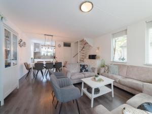 a living room with a couch and a table at Holiday Home in Zeeland with Garden Terrace in Wemeldinge