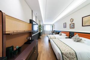 Letto o letti in una camera di Vishan Garden Boutique Hotel 厦门维尚花园潮宿 中山路步行街店