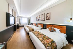 Letto o letti in una camera di Vishan Garden Boutique Hotel 厦门维尚花园潮宿 中山路步行街店