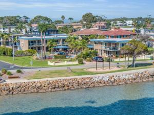 an aerial view of houses and the water at Lakeside Apartments 8 in Merimbula