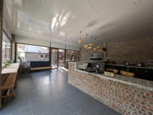 a restaurant with a counter and a brick wall at Seven Homestay in Ha Giang