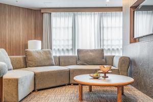 a living room with a couch and a coffee table at Apartment Hotel 11 Dotonbori4 in Osaka +22 photos