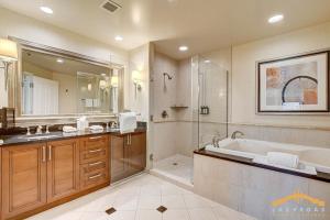 a bathroom with a tub and a shower and a sink at MGM Signature-03-611 Strip View Jacuzzi Studio in Las Vegas