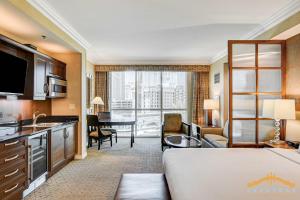 a hotel room with a bed and a living room at MGM Signature-03-611 Strip View Jacuzzi Studio in Las Vegas