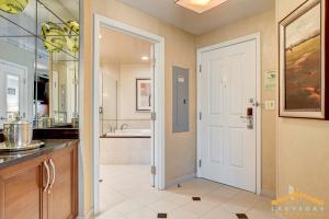 a kitchen with a sink and a door to a bathroom at MGM Signature-03-611 Strip View Jacuzzi Studio in Las Vegas