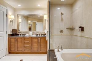 a bathroom with a tub and a sink and a mirror at MGM Signature-03-611 Strip View Jacuzzi Studio in Las Vegas