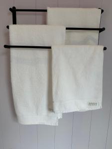 two white towels on a towel rack in a bathroom at Kūkupa Matairangi at Akaroa Lavender in Akaroa