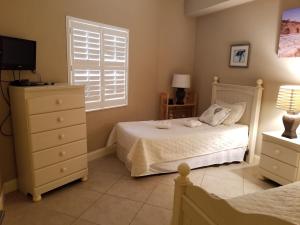 a bedroom with a white bed and a window at Surf Club I, 1405 in Marineland +32 photos