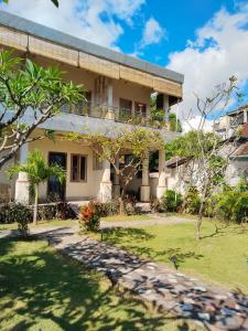 a house with a garden in front of it at Dolot Guest House Amed Beach in Amed +58 photos