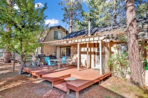a house with a wooden deck in the woods at Pines 23 #1438 in Big Bear Lake