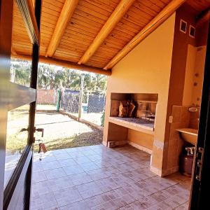 an outdoor kitchen with a fireplace in a house at La Casita El Martillo in Concordia