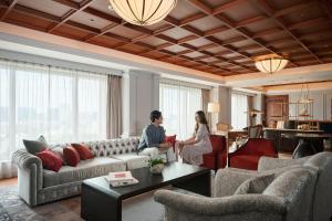 a man and a woman sitting in a living room at The Westin Tokyo in Tokyo