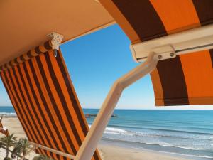 a beach chair with a view of the ocean at Valencia Port Saplaya in Port Saplaya