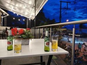 a table with two bottles and two glasses on it at Hotel Purobeach in Turbo