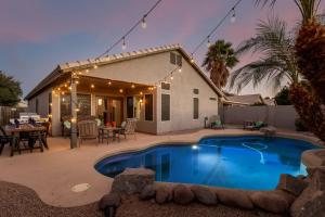 a backyard with a swimming pool and a house at 136th Surprise in Surprise