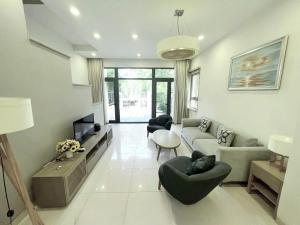 a living room with a couch and chairs and a tv at Căn 5 Phòng Ngủ - Villa Royal Lotus in Ha Long