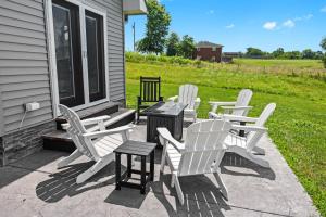 a group of white chairs and a table on a porch at Bourbon Trail Getaway Jacuzzi Tub Scenic Views in Waddy