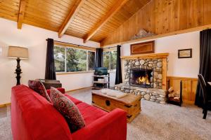 a living room with a red couch and a fireplace at Moulin rouge #2055 in Big Bear Lake