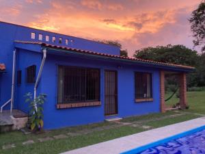 una casa azul al lado de una piscina en The Weiss House - Mountain, Pool and Rest, en Tepoztlán