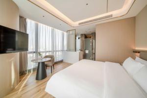 Bodun International Apartment Foshan Shunde Fengjian Water Village Branch客房内的一张或多张床位