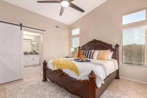 a bedroom with a large bed and a ceiling fan at 136th Surprise in Surprise +35 photos