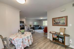 a living room with a table and a kitchen at It's The Melody! in Boise