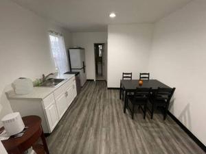 a kitchen and dining room with a table and chairs at Laguardia Room 2 in North Beach